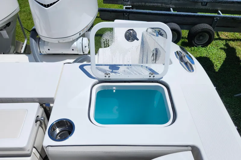 Slide: The Image of 2026 Pursuit S 328 Sport boat storage compartment with open hatch and visible equipment. - 14