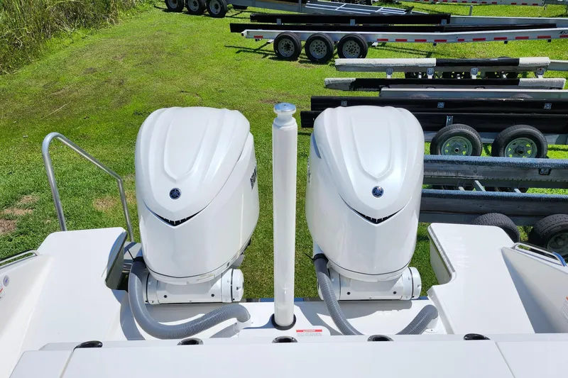 Slide: The Image of 2026 Pursuit S 328 Sport boat with open storage compartment and dual engines. - 18