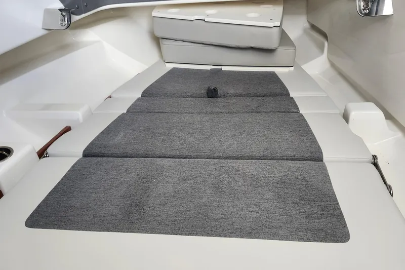 Slide: The Image of 2026 Pursuit S 328 Sport boat with dual outboard engines on a grassy area. - 20