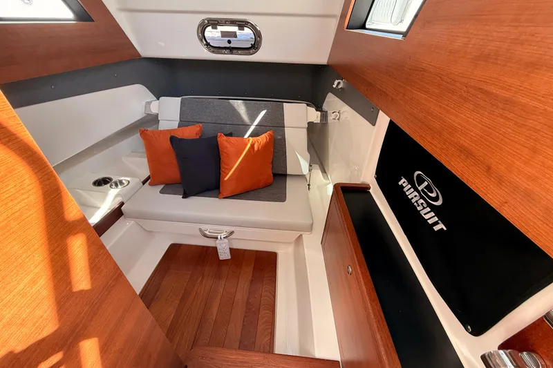 Slide: The Image of Interior of 2026 Pursuit S 328 Sport boat with cushions and wood accents. - 57