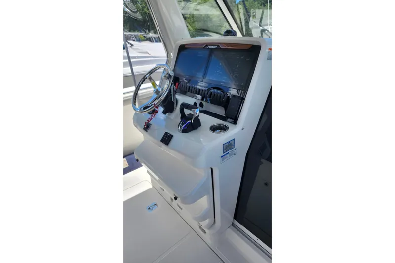 Slide: The Image of 2026 Pursuit S 328 Sport boat with luxurious, quilted gray seating. - 6