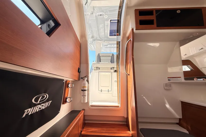 Slide: The Image of Interior view of 2026 Pursuit S 328 Sport boat, featuring wood accents and modern design. - 60