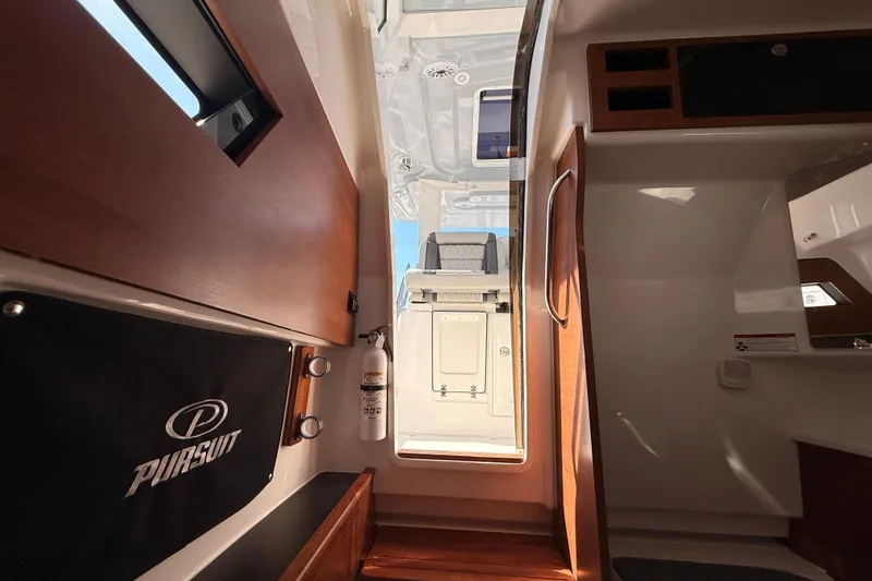 Slide: The Image of Interior view of 2026 Pursuit S 328 Sport boat, featuring wood accents and modern design. - 61
