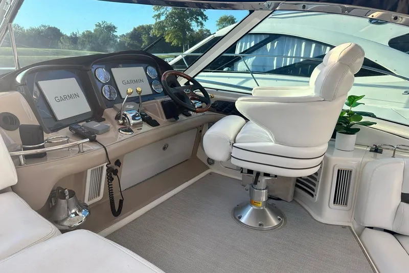 Slide: The Image of 2006 Sea Ray 52 Sundancer helm with Garmin displays and white captain's chair. - 14
