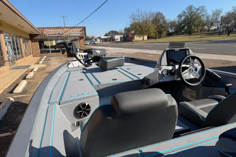 Slide: The Image of 2026 Xpress H17 boat interior with steering wheel, seats, and control panel at Shipps Marine. - 4
