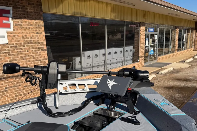 Slide: The Image of 2026 Xpress H17 boat with advanced control panel, parked outside a brick building. - 8