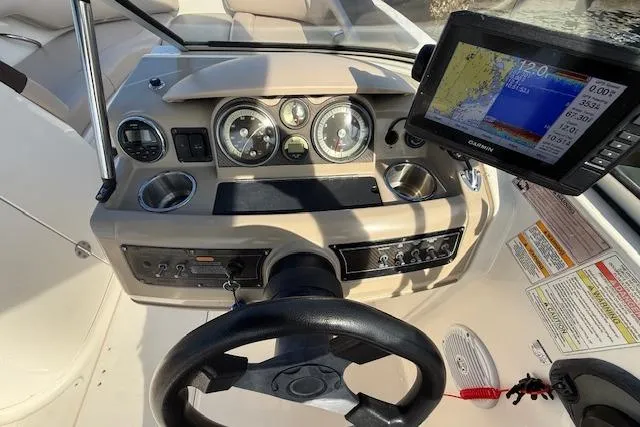 Slide: The Image of Dashboard of a 2015 Bayliner 210 Deck Boat with navigation system and gauges. - 15