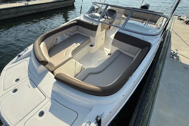 Slide: The Image of 2015 Bayliner 210 Deck Boat docked, featuring spacious seating and sleek design. - 16