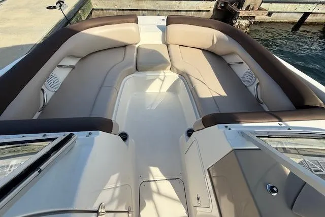 Slide: The Image of 2015 Bayliner 210 Deck Boat interior with spacious seating and beige upholstery. - 17