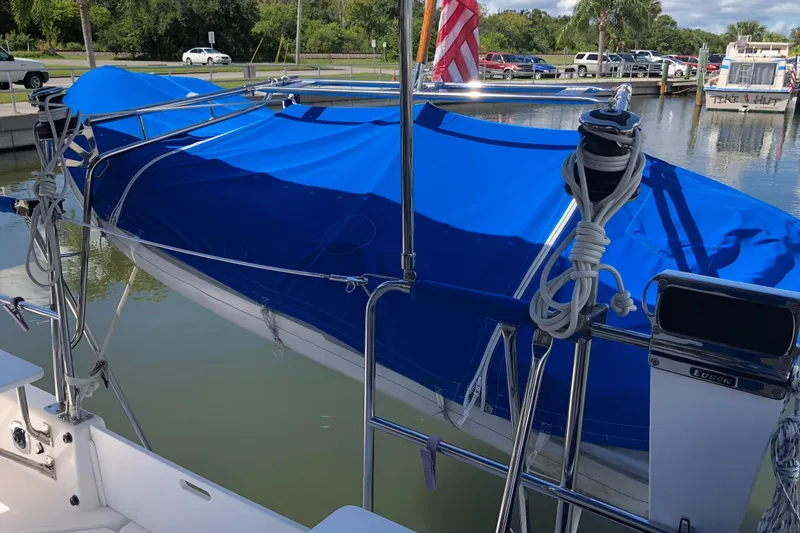 Slide: The Image of 2002 Endeavour Trawlercat 36 with blue cover docked at marina. - 16