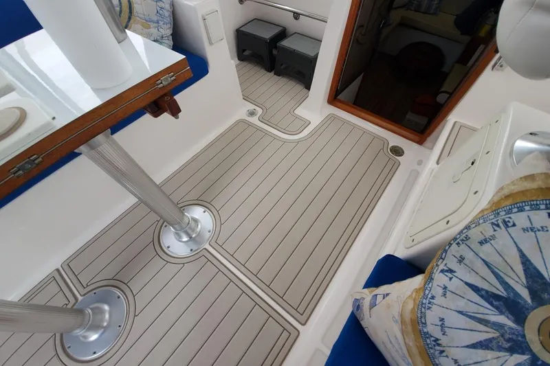 Slide: The Image of 2002 Endeavour Trawlercat 36 interior with sleek flooring and nautical-themed decor. - 21