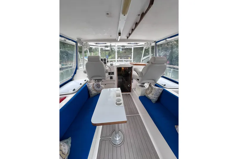 Slide: The Image of Interior of 2002 Endeavour Trawlercat 36 with blue seating and helm station. - 22