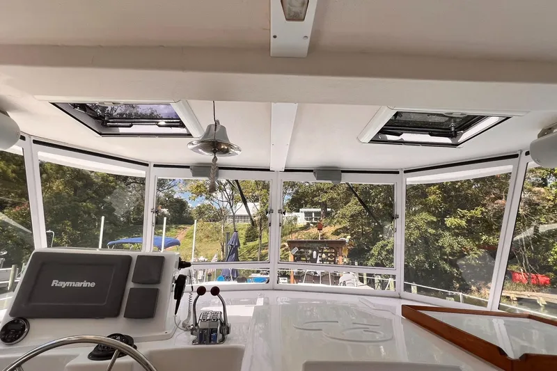 Slide: The Image of Interior view of 2002 Endeavour Trawlercat 36 helm with Raymarine equipment and panoramic windows. - 23