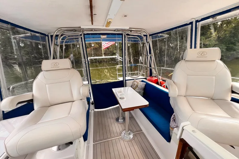 Slide: The Image of Interior of 2002 Endeavour Trawlercat 36 with plush seating and table, overlooking water. - 25