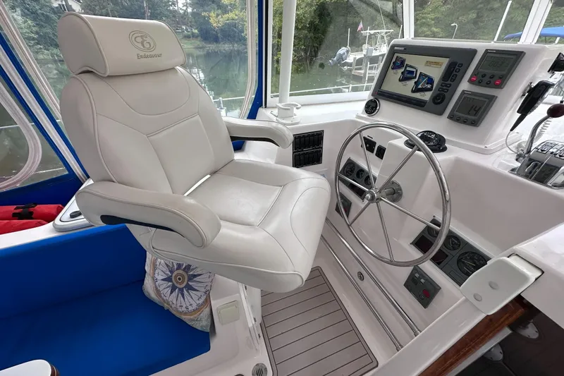 Slide: The Image of Helm of 2002 Endeavour Trawlercat 36 with captain's chair and navigation controls. - 26