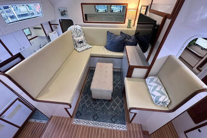 Slide: The Image of Interior of 2002 Endeavour Trawlercat 36 with cozy seating and nautical decor. - 29