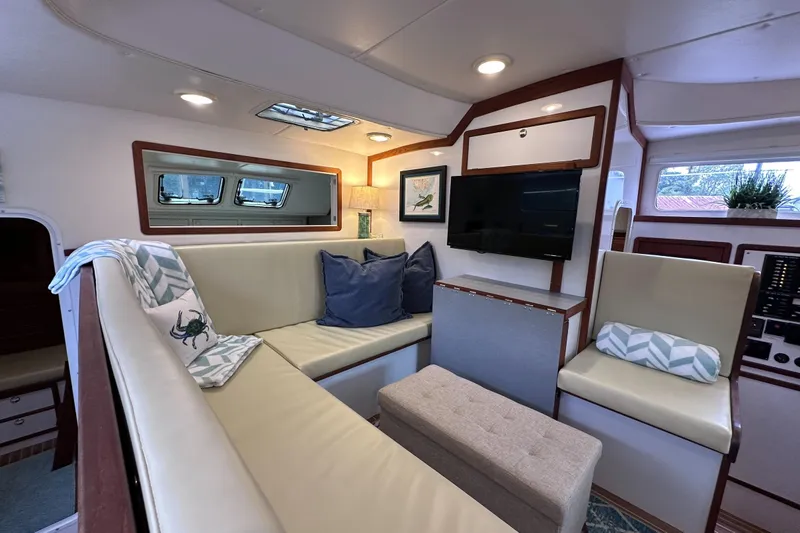 Slide: The Image of Interior of 2002 Endeavour Trawlercat 36 with cozy seating, TV, and nautical decor. - 30