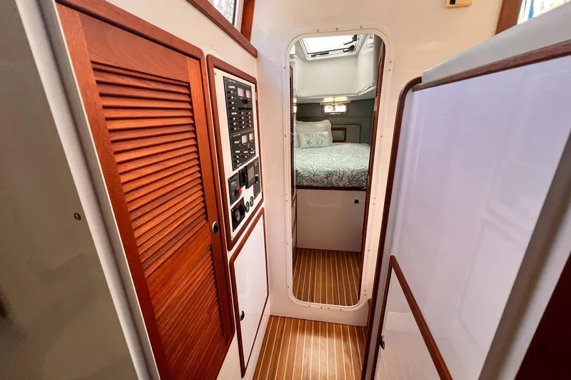 Slide: The Image of Interior of 2002 Endeavour Trawlercat 36, featuring wood paneling and cozy cabin. - 33