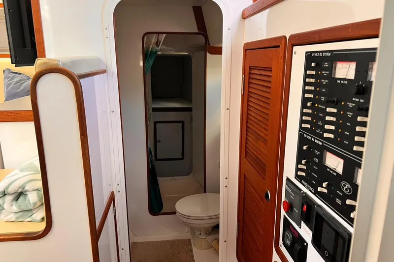 Slide: The Image of Interior of 2002 Endeavour Trawlercat 36, featuring control panel and compact bathroom. - 34