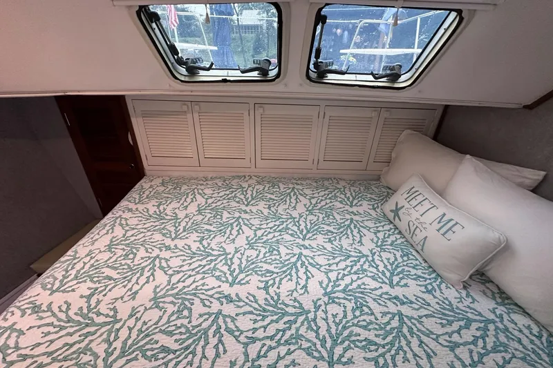 Slide: The Image of Cozy cabin interior of 2002 Endeavour Trawlercat 36 with nautical-themed bedding. - 39