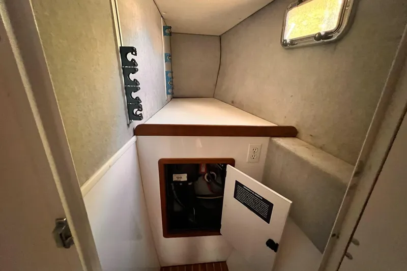 Slide: The Image of 2002 Endeavour Trawlercat 36 interior cabin with storage compartment and small window. - 44