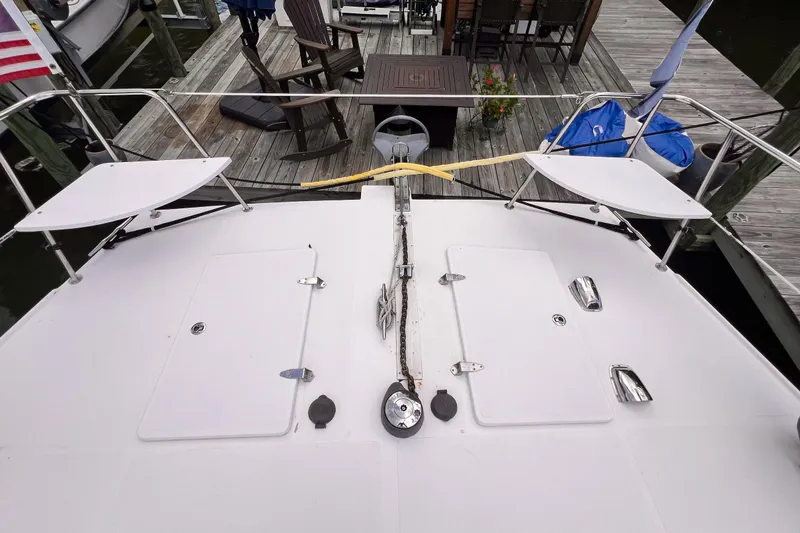 Slide: The Image of Bow view of 2002 Endeavour Trawlercat 36 docked, featuring deck hatches and seating. - 5