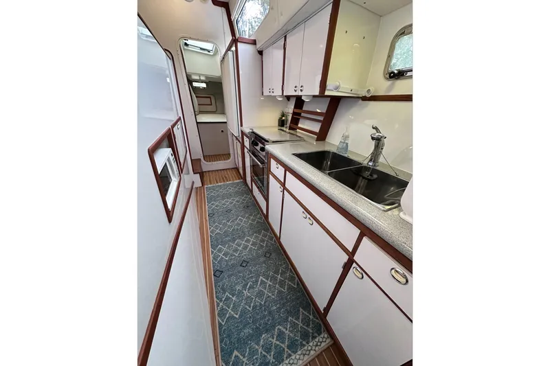 Slide: The Image of 2002 Endeavour Trawlercat 36 galley with modern appliances and sleek cabinetry. - 50