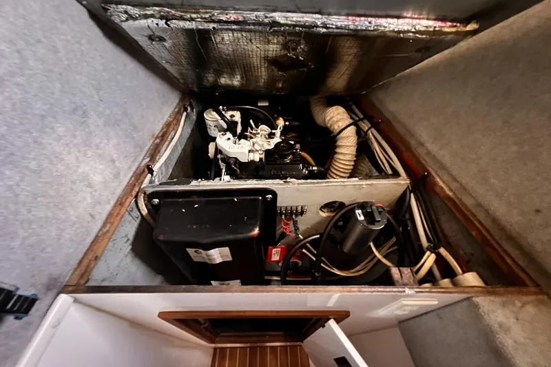 Slide: The Image of Engine compartment of 2002 Endeavour Trawlercat 36, showcasing mechanical components and wiring. - 53