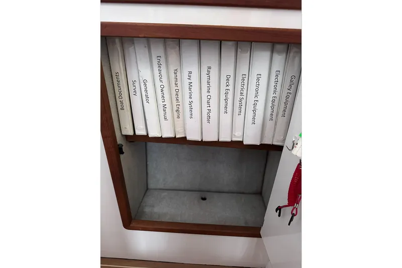 Slide: The Image of Manuals and documents in a cabinet on a 2002 Endeavour Trawlercat 36 boat. - 54