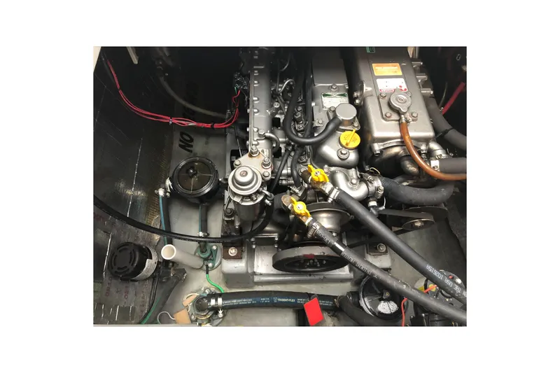 Slide: The Image of Engine compartment of a 2002 Endeavour Trawlercat 36, showcasing mechanical components and wiring. - 57