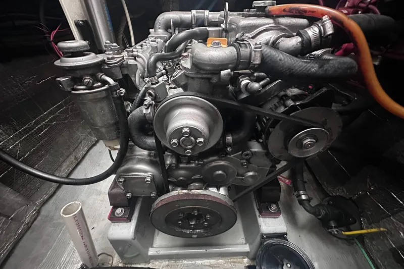 Slide: The Image of Engine of 2002 Endeavour Trawlercat 36, showcasing mechanical components and hoses. - 59