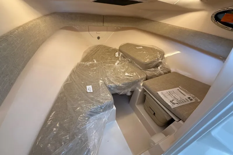 Slide: The Image of Interior cabin of 2026 Grady-White Adventure 218 boat with cushioned seating. - 10