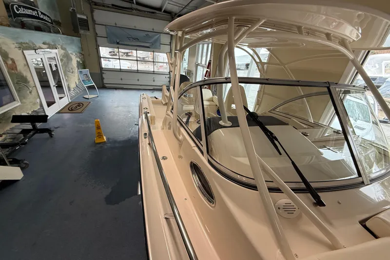 Slide: The Image of 2026 Grady-White Adventure 218 boat displayed indoors, showcasing sleek design and modern features. - 12