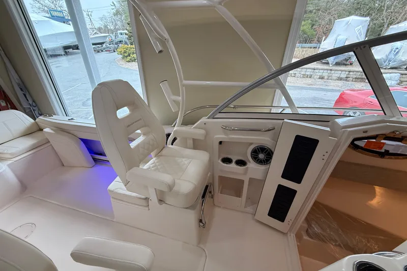 Slide: The Image of Interior of 2026 Grady-White Adventure 218 boat, featuring helm seat and dashboard controls. - 9