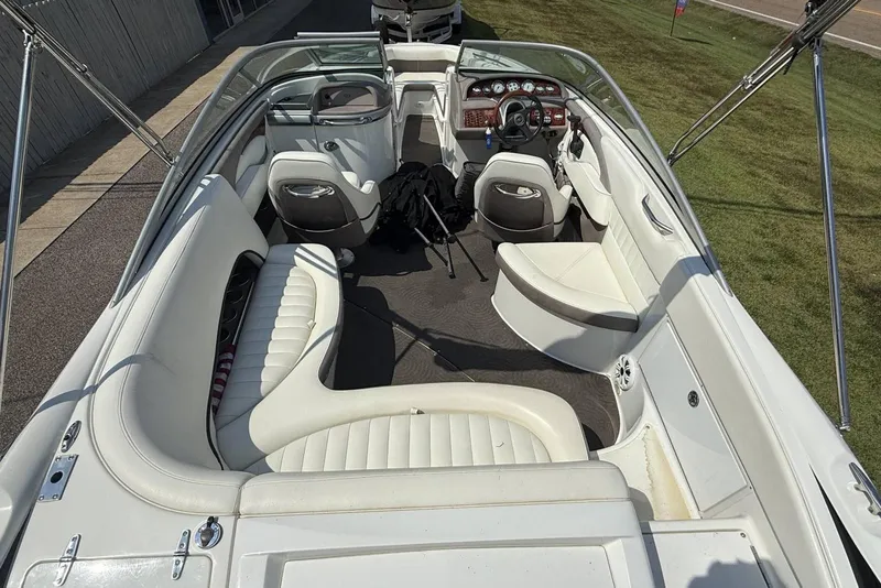 Slide: The Image of 2005 Cobalt 240 boat interior with white seating and dashboard view. - 16