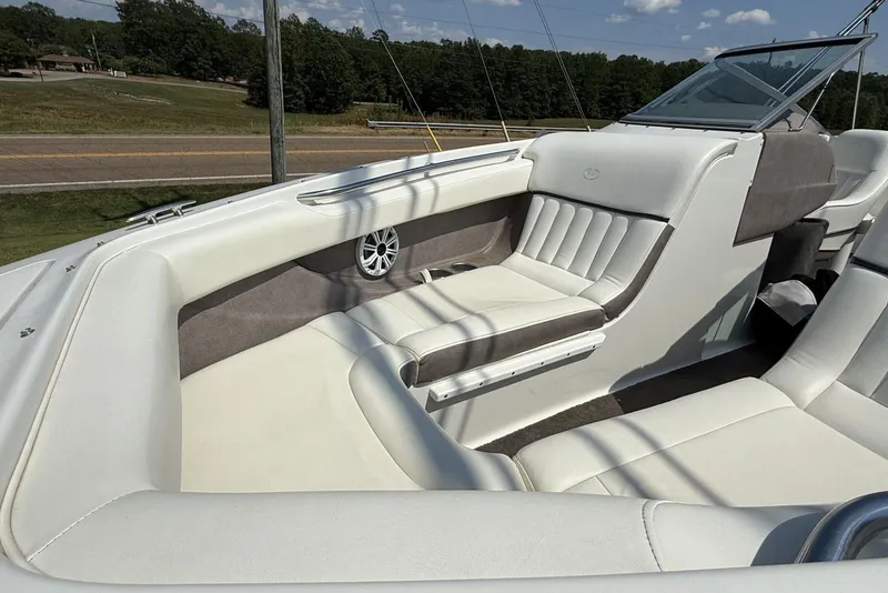 Slide: The Image of 2005 Cobalt 240 boat interior with white and gray seating, speaker, and windshield. - 5