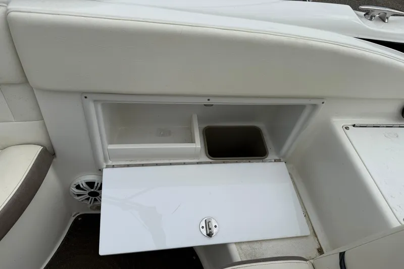 Slide: The Image of 2005 Cobalt 240 boat interior storage compartment with open lid and speaker. - 6