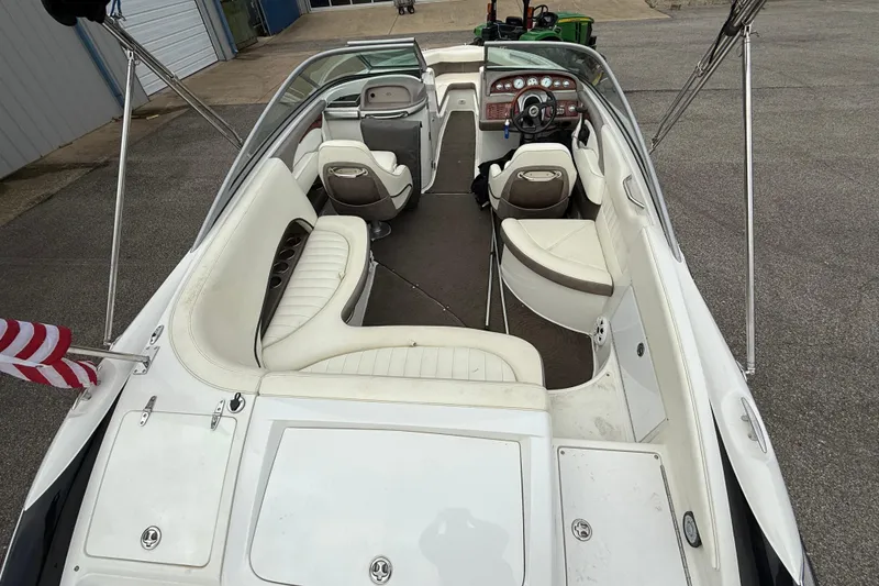 Slide: The Image of Interior view of a 2005 Cobalt 240 boat with white seating and dashboard. - 9