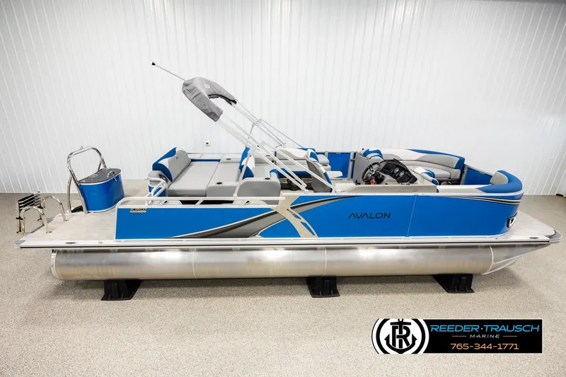 The Image of 2026 Avalon LSZ Vrl pontoon boat in showroom, blue and silver design, side view. - 1