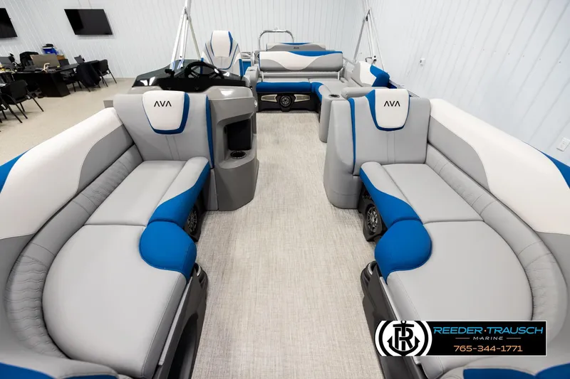 Slide: The Image of 2026 Avalon LSZ Vrl pontoon boat interior with blue and gray seating, displayed indoors. - 13