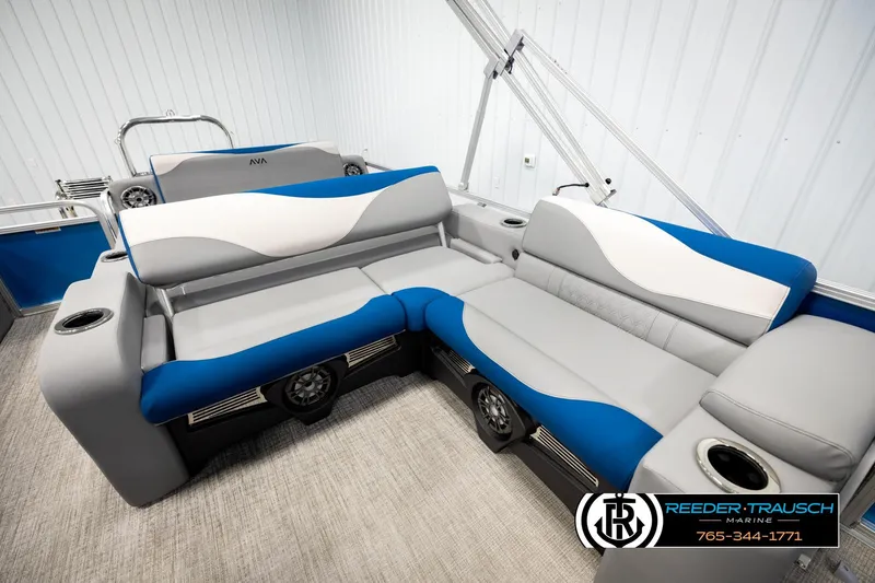 Slide: The Image of 2026 Avalon LSZ Vrl boat interior with blue and gray seating, cup holders, and speakers. - 21