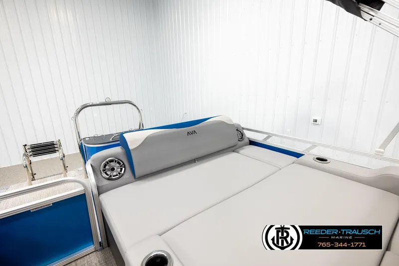 Slide: The Image of 2026 Avalon LSZ Vrl boat interior with gray seating and blue accents in a showroom. - 23