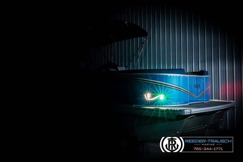 Slide: The Image of 2026 Avalon LSZ Vrl boat with illuminated lights in a dimly lit setting. - 4