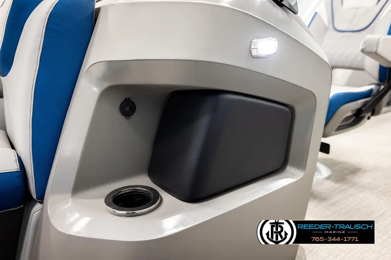 Slide: The Image of 2026 Avalon LSZ Vrl boat interior with blue and white seating, cup holder, and storage compartment. - 44