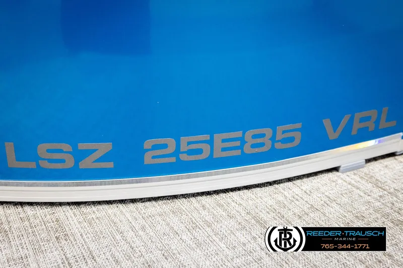 Slide: The Image of 2026 Avalon LSZ Vrl boat with blue exterior and Reeder-Trausch Marine branding. - 47