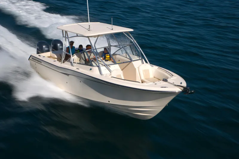 The Image of 2025 Grady-White 275 boat cruising swiftly on open water. - 1