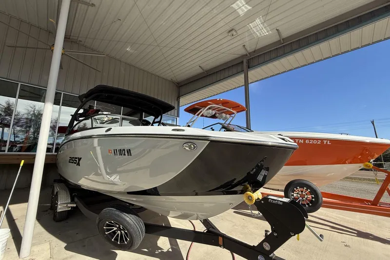 Slide: The Image of 2024 Yamaha Boats 255XD displayed in a showroom, showcasing sleek design and modern features. - 10