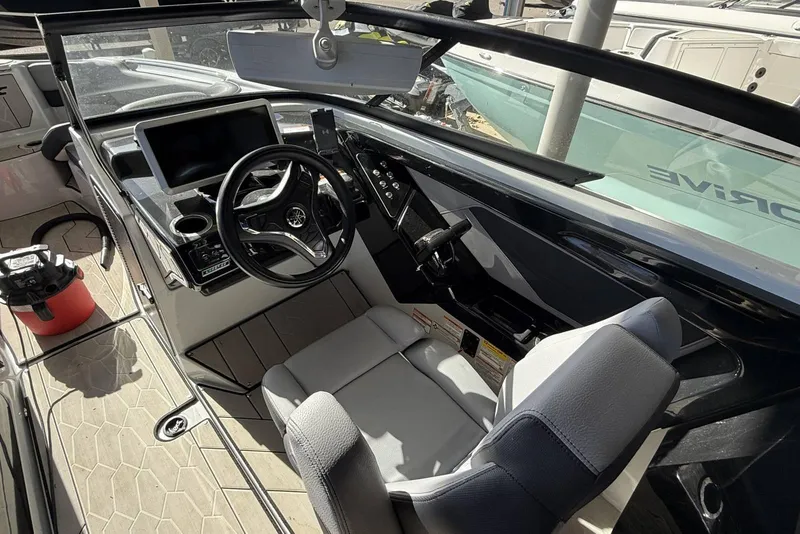 Slide: The Image of 2024 Yamaha Boats 255XD cockpit with modern steering and control panel. - 14