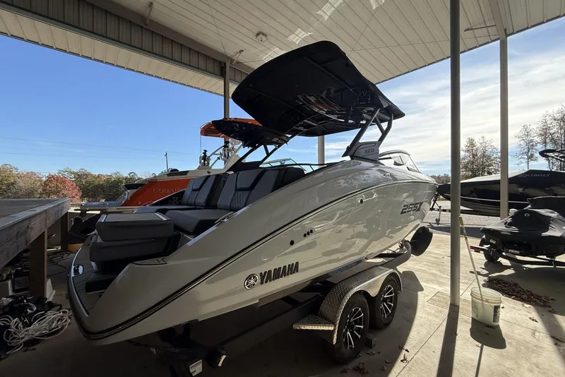 Slide: The Image of 2024 Yamaha Boats 255XD in showroom, sleek design, parked on trailer. - 9