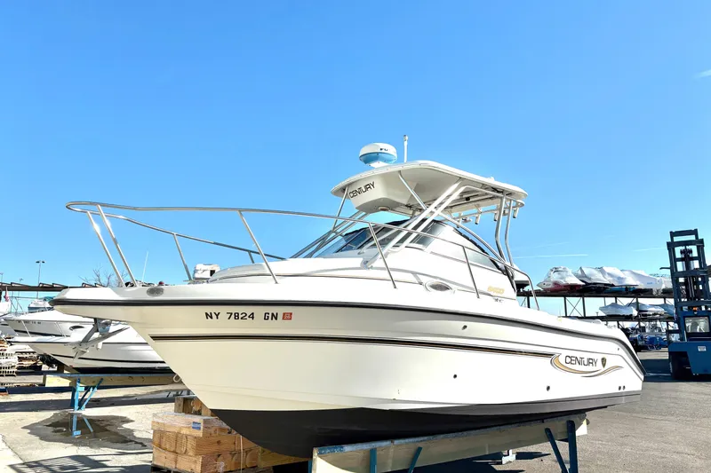 The Image of 2006 Century 2400 Walkaround boat on display under clear blue sky. - 0